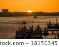 Various ships  in a harbor at sunset 18150345
