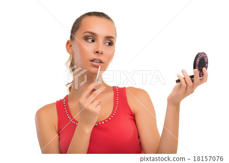 Beautiful girl paints lips. 18157076