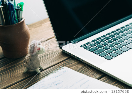 Workplace with open laptop on modern wooden desk  18157668