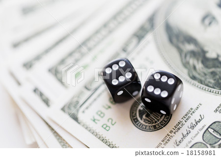 close up of black dice and dollar cash money close up of black dice and dollar cash money 18158981