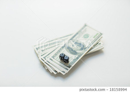 close up of black dice and dollar cash money close up of black dice and dollar cash money 18158994