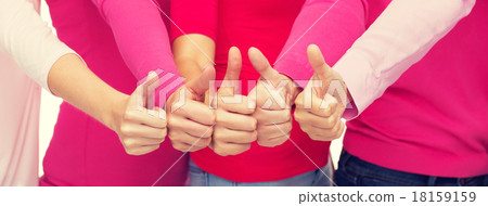 close up of women in pink shirts showing thumbs up close up of women in pink shirts showing thumbs up 18159159
