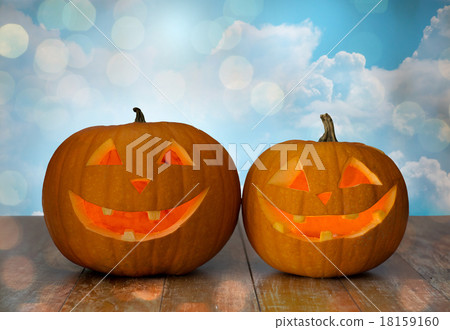 close up of carved halloween pumpkins on table close up of carved halloween pumpkins on table 18159160