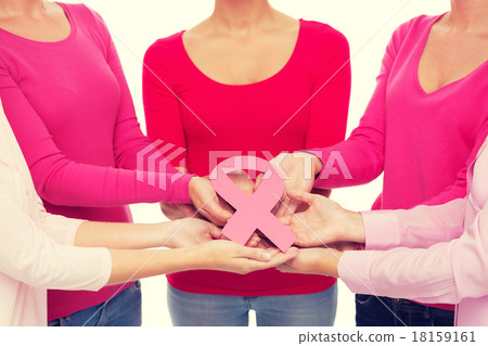 close up of women with cancer awareness ribbons close up of women with cancer awareness ribbons 18159161