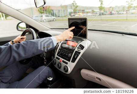 close up of young man with tablet pc driving car close up of young man with tablet pc driving car 18159226