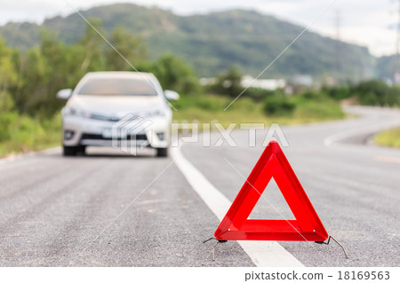 Red emergency stop sign and broken silver car 18169563