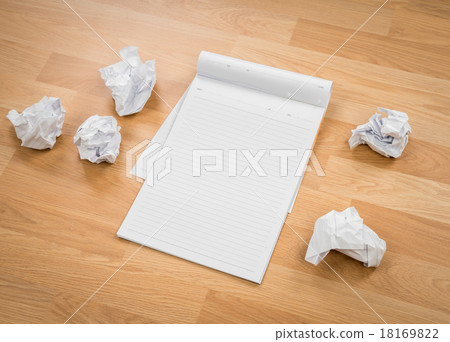 White note book paper with crumpled paper on a wooden desk White note book paper with crumpled paper on a wooden desk 18169822