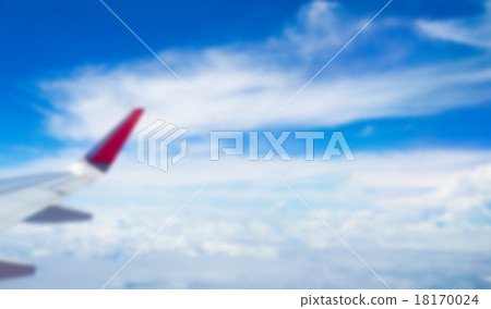 Abstract blur Wing of an airplane flying above the clouds 18170024