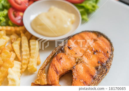Grilled salmon steak meal served with salad and French fries 18170085