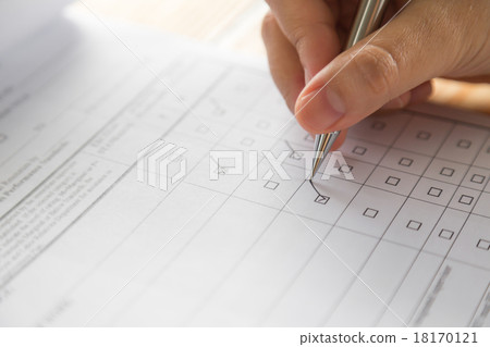 Hand with pen over application form 18170121