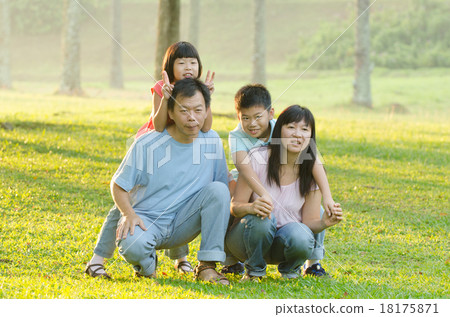 Family lying outdoors being playful and smiling, Outddor portrai 18175871