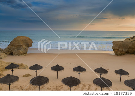 Dramatic views of the beach with umbrellas. 18177339