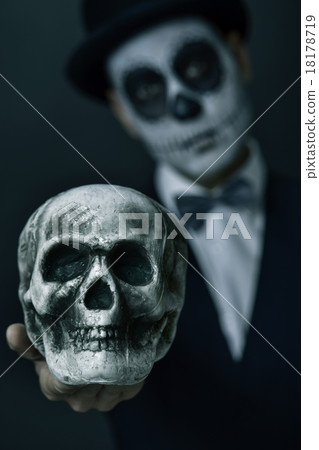 man with mexican calaveras makeup showing a skull man with mexican calaveras makeup showing a skull 18178719