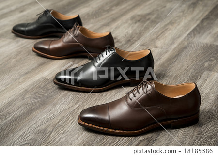 Black and brown leather shoes for men turn side by side Black and brown leather shoes for men turn side by side 18185386