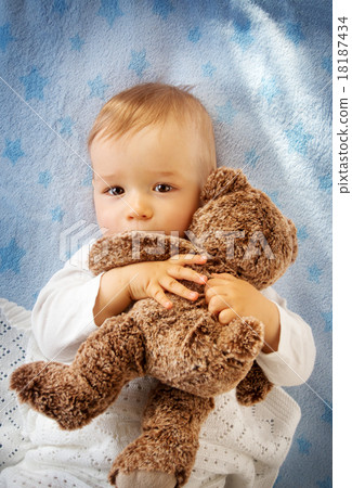 One year old baby holding a teddy bear One year old baby holding a teddy bear 18187434