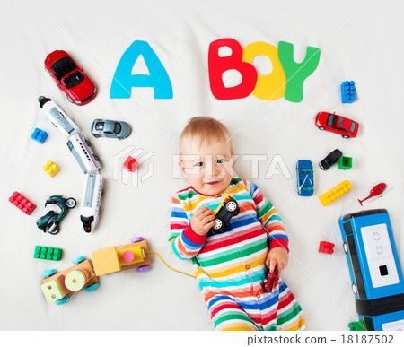 Baby boy lying on the blanket with letters above Baby boy lying on the blanket with letters above 18187502