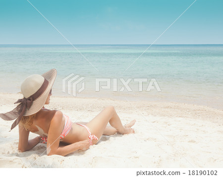 Woman in bikini at tropical beach 18190102