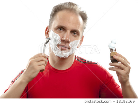 sports man has a shave- with the razor and a small 18192169
