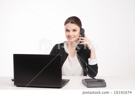 Young woman with laptop talking on the phone Young woman with laptop talking on the phone 18192874
