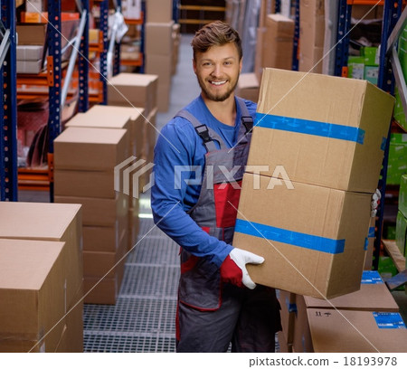 Porter carrying boxes in a warehouse Porter carrying boxes in a warehouse 18193978