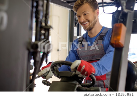 Man driving forklift truck on a warehouse Man driving forklift truck on a warehouse 18193981