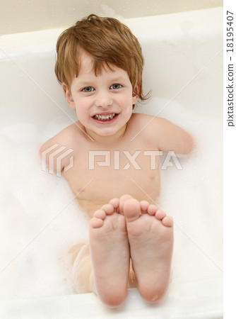 Cute three year old boy taking a bath with foam 18195407