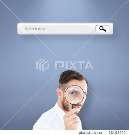 Composite image of geeky businessman looking through magnifying 18198831