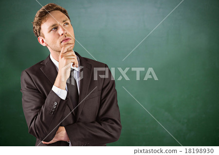 Composite image of young businessman thinking with hand on chin 18198930
