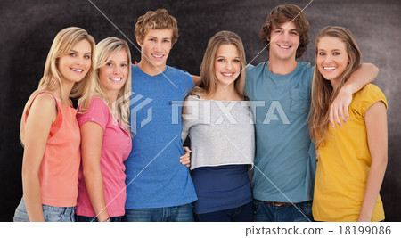 Composite image of a group of friends smiling and holding each o 18199086