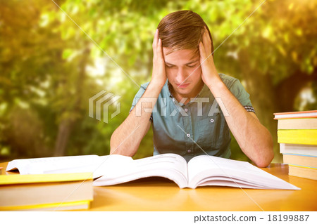 Composite image of student sitting in library reading Composite image of student sitting in library reading 18199887