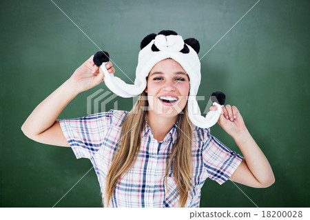 Composite image of geeky hipster smiling at camera Composite image of geeky hipster smiling at camera 18200028