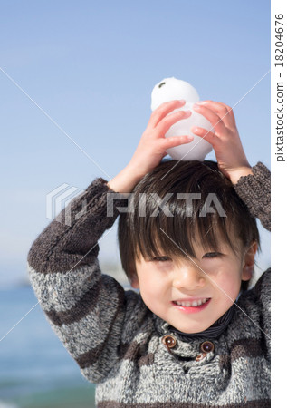 Coastal scenery with children playing in the snow 18204676