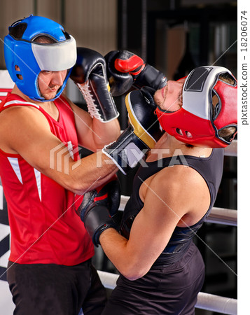 Two men boxer wearing helmet boxing . Two men boxer wearing helmet boxing . 18206074