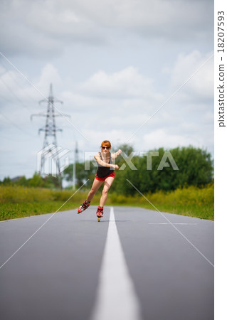 Attractive girl rollerblading on the road Attractive girl rollerblading on the road 18207593