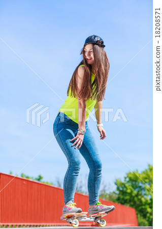 Teen girl skater riding skateboard on street. 18208571