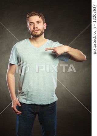 Man guy in blank shirt with copy space pointing. 18208637