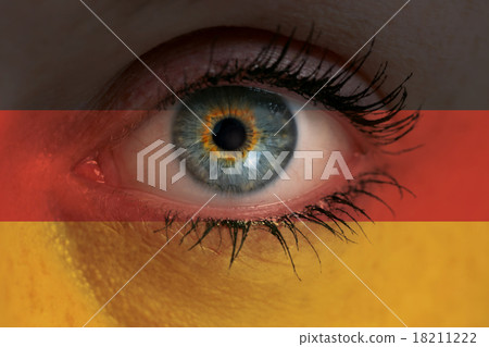 Eye looks through Germany flag background concept macro Eye looks through Germany flag background concept macro 18211222