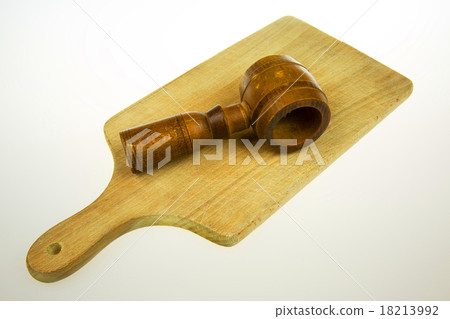 Old wooden nutcracker on the worktop on a white Old wooden nutcracker on the worktop on a white 18213992