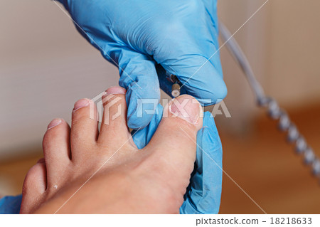 Pedicure Spa. Shaping nails and cuticles closeup. Pedicure Spa. Shaping nails and cuticles closeup. 18218633