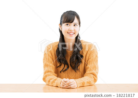 White back pose of a teenage woman sitting wearing a sweater 18221817