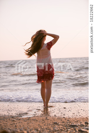 Woman with long hair on the beach Woman with long hair on the beach 18222662