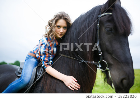 Beautiful young girl riding a horse in countryside Beautiful young girl riding a horse in countryside 18222826