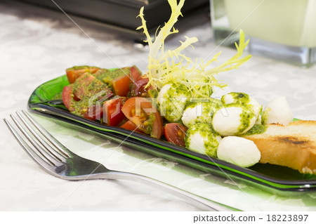 Caprese salad with tomatoes and cheese in a plate Caprese salad with tomatoes and cheese in a plate 18223897