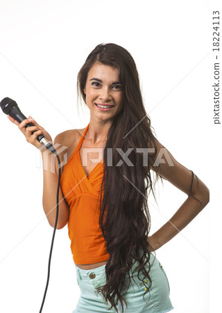 Lovely woman in orange shirt with microphone. Lovely woman in orange shirt with microphone. 18224113