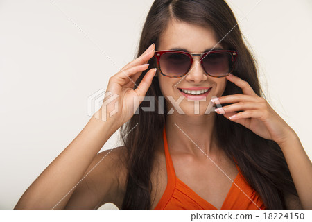 Nice lady in orange shirt is smiling. 18224150