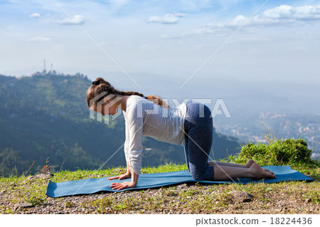 Sporty fit woman practices yoga asana bitilasana Sporty fit woman practices yoga asana bitilasana 18224436