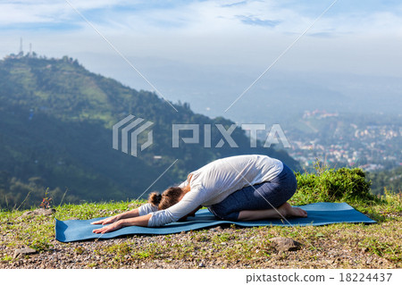 Sporty fit woman practices yoga asana Balasana Sporty fit woman practices yoga asana Balasana 18224437