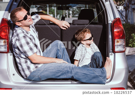 Happy father and son getting ready for road trip on a sunny day 18226537