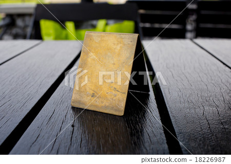 Blank old brown leather table card on wood table. 18226987