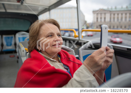 Pensioner woman taking photos by phone in touristi 18228570